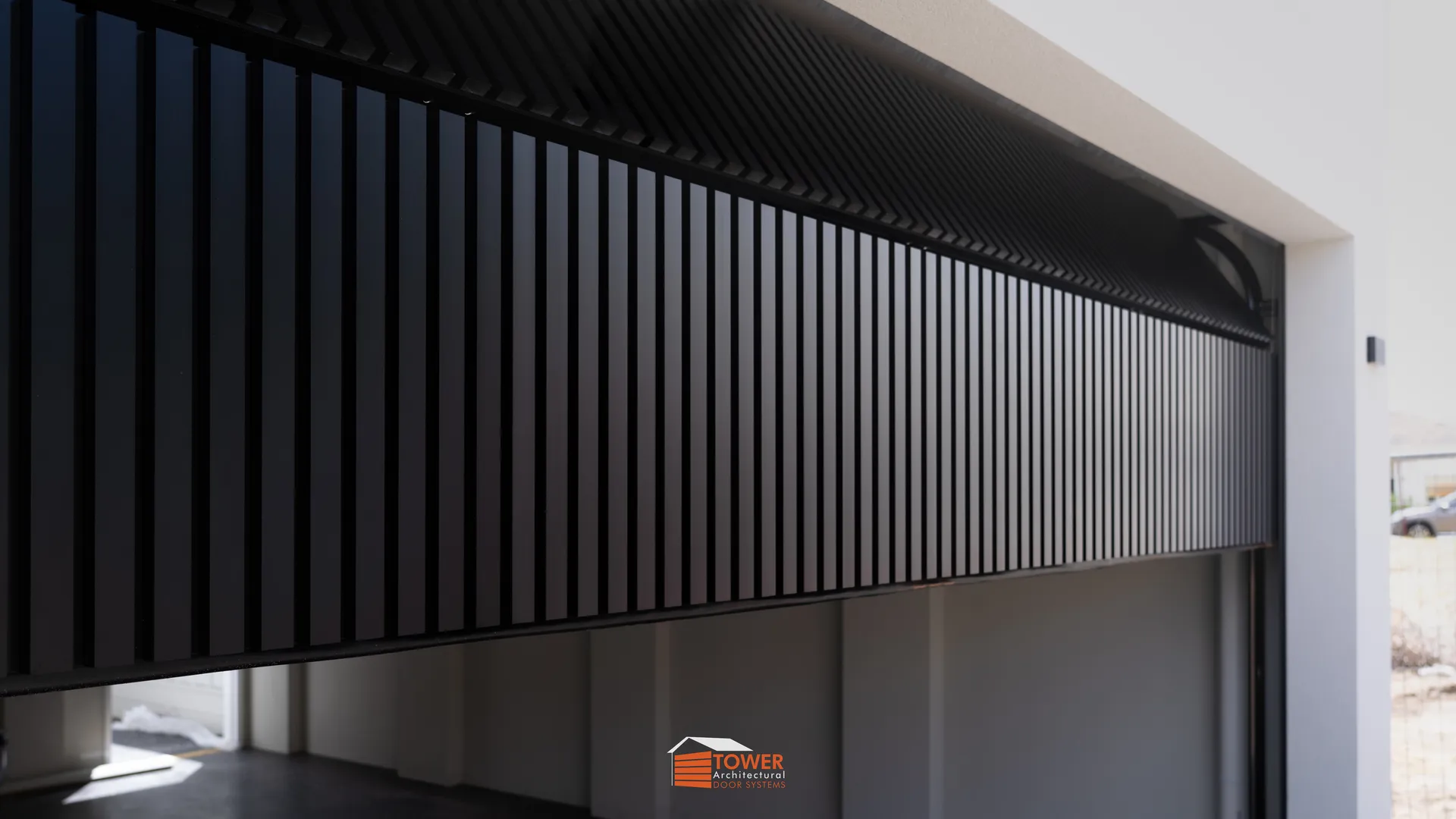 Architectural Range — Batten Series Location: Perth Style Profile: A sleek and contemporary coastal statement, this project showcases dual Flushmount Pro doors finished in Textura Black.