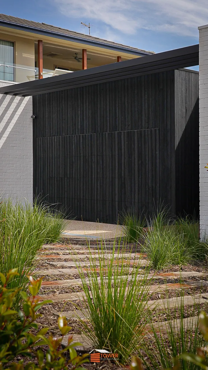 Architectural Range — Natural Series (Shiplap) Location: Melbourne Builder: Latitude 37 Style Profile: A seamless Flushmount Pro door clad in shou sugi ban —finished shiplap timber , delivering a rich, dark, textural façade with a premium architectural edge.