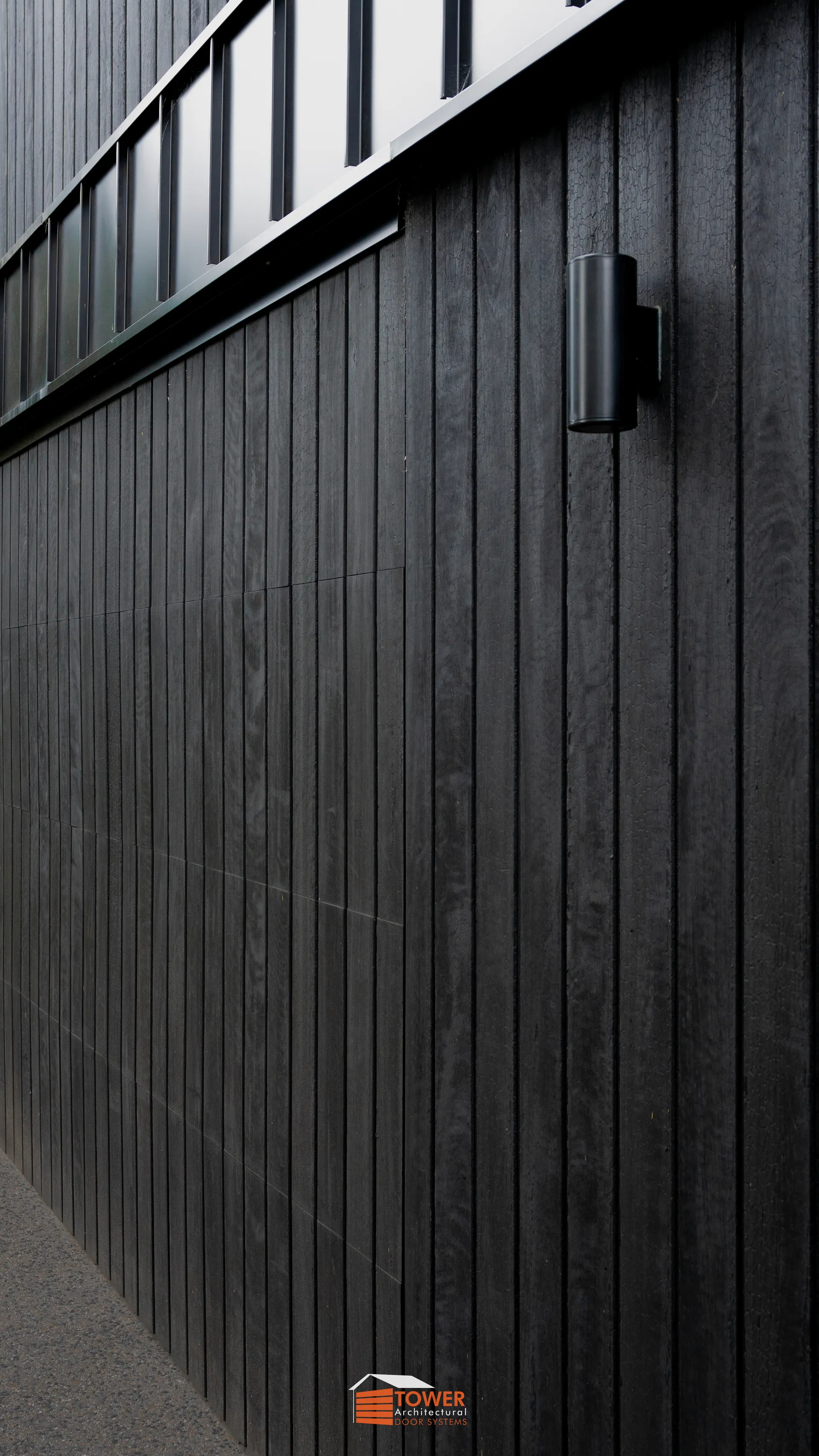 Architectural Range — Natural Series Location: Melbourne Builder: Blackwood Builders Style Profile: A bold and moody architectural statement, this project features a Flushmount Pro door clad in deep-toned natural timber shiplap.