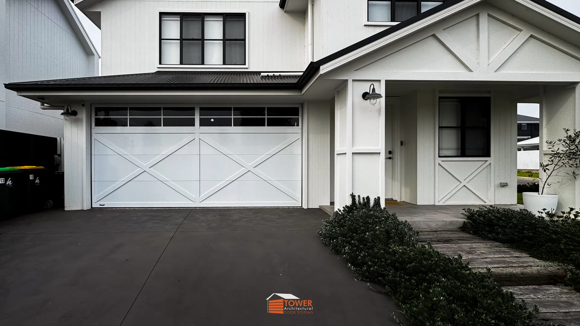 Architectural Range — XBarn Series Location: Sydney Style Profile: A crisp and refined interpretation of the classic barn-style door, this XBarn Series installation showcases a Gloss White finish that elevates the façade with brightness and clean architectural lines.